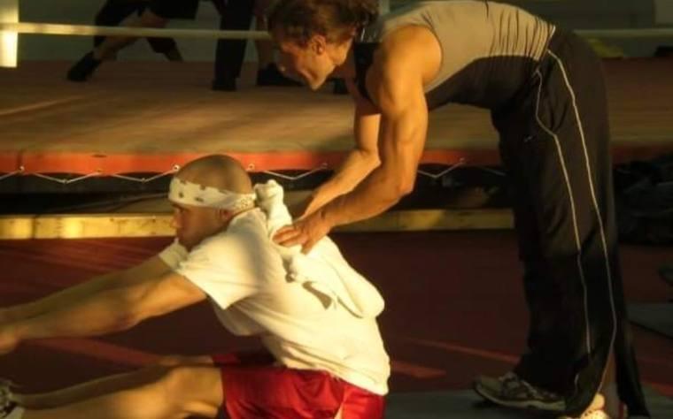 Sam Mujkic stretching a fighter at ringside